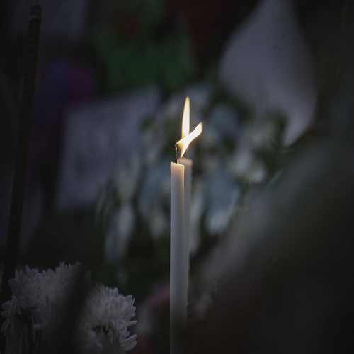 White candle with a small flame